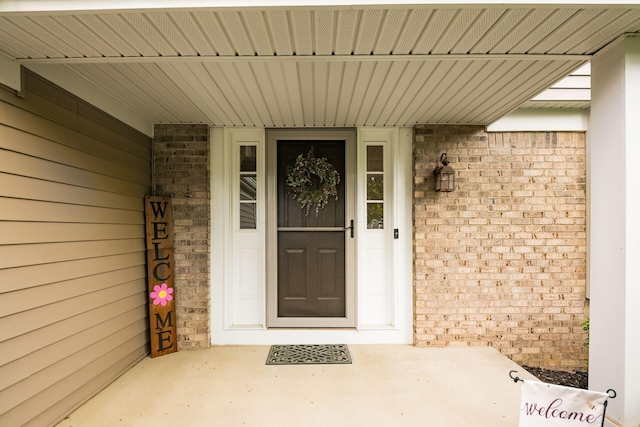 property entrance with brick siding