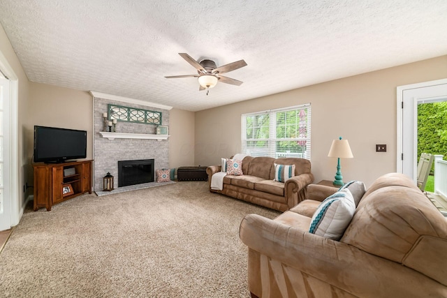 carpeted living area featuring a ceiling fan, a textured ceiling, and a fireplace