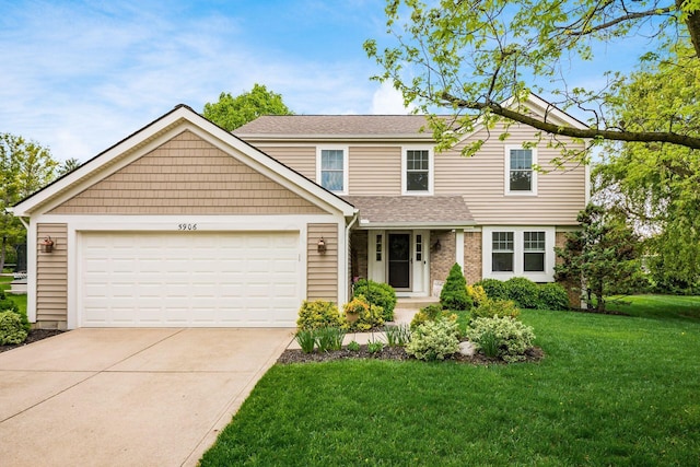 traditional-style home featuring concrete driveway, a front yard, a garage, and roof with shingles