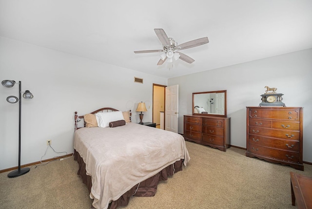 bedroom featuring light colored carpet, baseboards, and ceiling fan