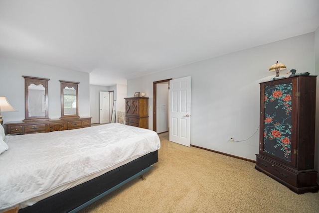 carpeted bedroom featuring baseboards