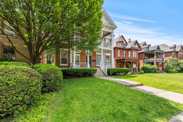 1205 Bryden Rd Unit 7, Columbus, OH 43205 - multi unit property with covered porch, brick siding, a front yard, and a balcony