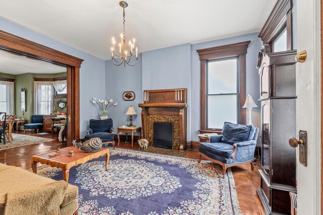 1205 Bryden Rd Unit 7, Columbus, OH 43205 - living area with a chandelier, wood finished floors, and a brick fireplace