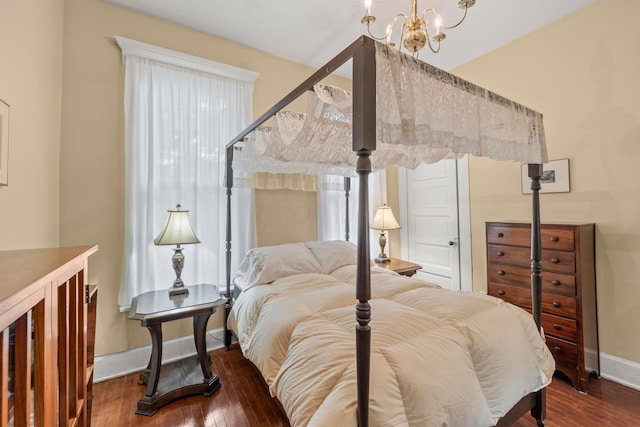 1205 Bryden Rd Unit 7, Columbus, OH 43205 - bedroom with a chandelier, wood-type flooring, and baseboards