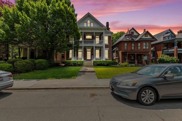 1205 Bryden Rd Unit 7, Columbus, OH 43205 - greek revival house featuring a balcony, covered porch, and a front yard
