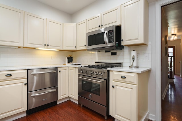 1660 Ridgeway Pl, Columbus, OH 43212 - kitchen featuring appliances with stainless steel finishes, dark wood-type flooring, tasteful backsplash, and light stone countertops