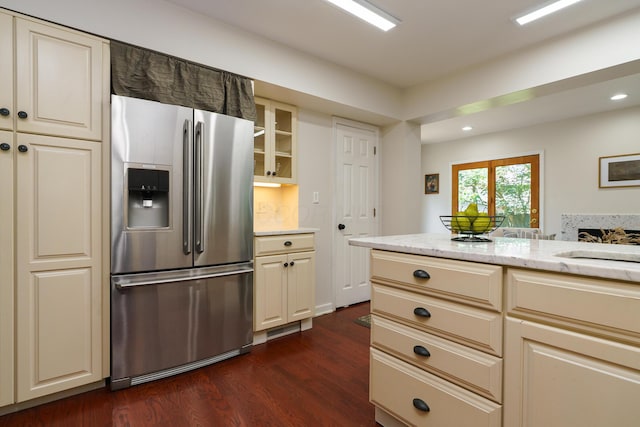 1660 Ridgeway Pl, Columbus, OH 43212 - kitchen with stainless steel fridge with ice dispenser, dark wood finished floors, recessed lighting, light stone counters, and glass insert cabinets