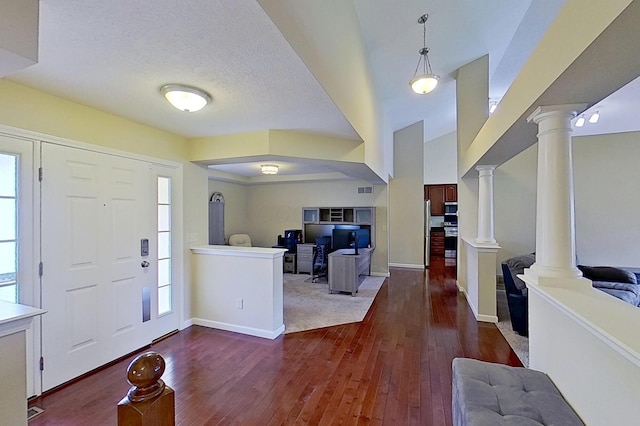foyer with decorative columns, dark wood-style floors, baseboards, and a textured ceiling