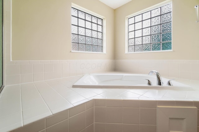 bathroom with plenty of natural light and a bath