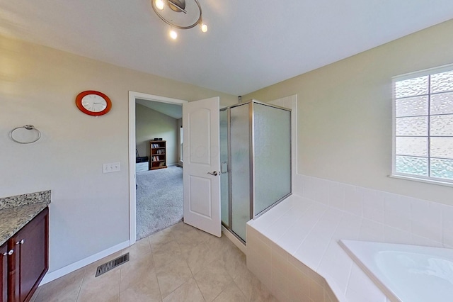 full bath featuring healthy amount of natural light, a stall shower, a bath, and tile patterned flooring