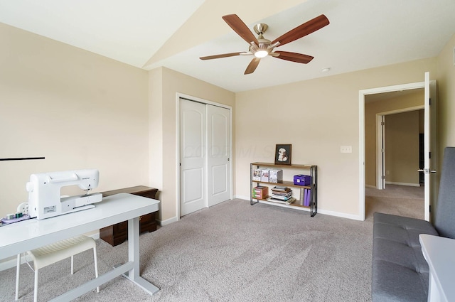 carpeted office featuring a ceiling fan and baseboards