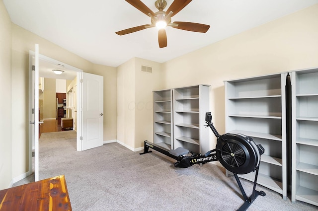 workout room featuring carpet floors, baseboards, and ceiling fan