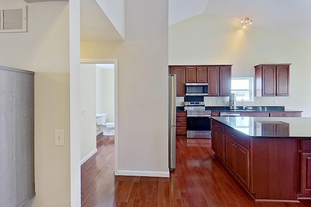 kitchen featuring appliances with stainless steel finishes, high vaulted ceiling, dark wood-style flooring, and a sink