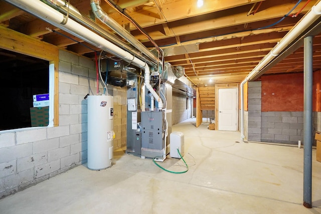 unfinished below grade area with electric water heater, heating unit, and concrete block wall