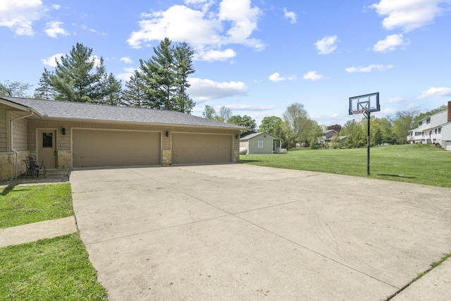 2825 Kings Corners Rd E, Mansfield, OH 44904 - view of side of home with a yard, concrete driveway, stone siding, and a garage