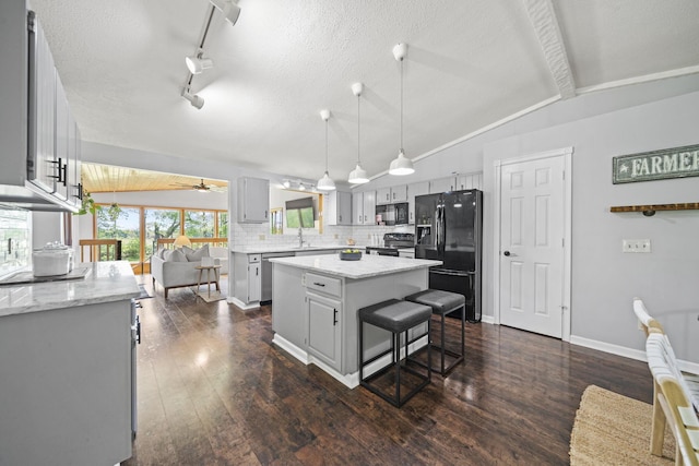 2825 Kings Corners Rd E, Mansfield, OH 44904 - kitchen with black appliances, a sink, ceiling fan, a kitchen island, and vaulted ceiling