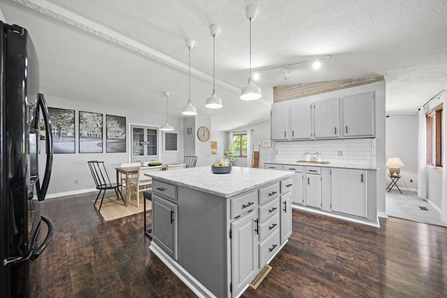 2825 Kings Corners Rd E, Mansfield, OH 44904 - kitchen with freestanding refrigerator, dark wood finished floors, baseboards, a textured ceiling, and decorative light fixtures