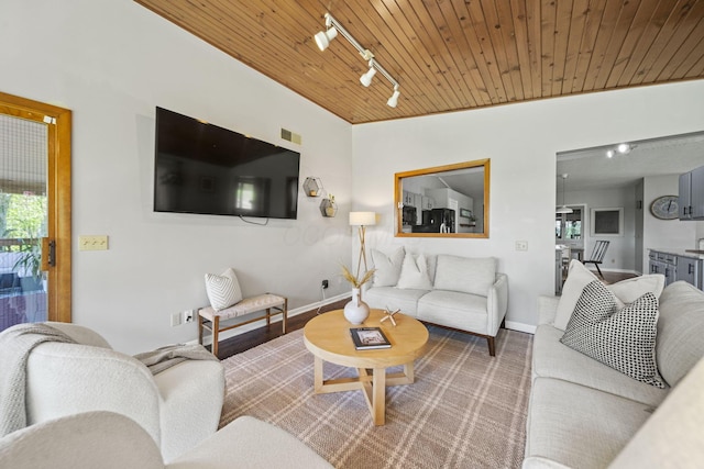 2825 Kings Corners Rd E, Mansfield, OH 44904 - living area featuring rail lighting, wood ceiling, and baseboards
