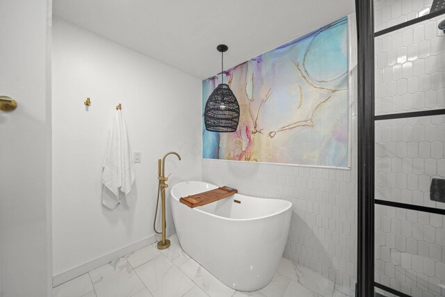 2825 Kings Corners Rd E, Mansfield, OH 44904 - bathroom with marble finish flooring, a freestanding bath, and baseboards