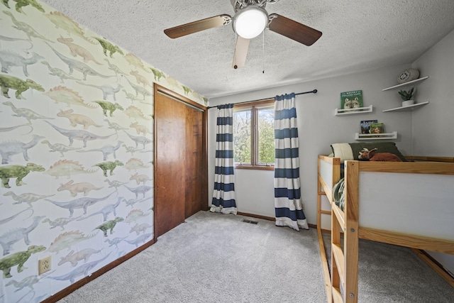 2825 Kings Corners Rd E, Mansfield, OH 44904 - carpeted bedroom with a textured ceiling, a closet, and a ceiling fan