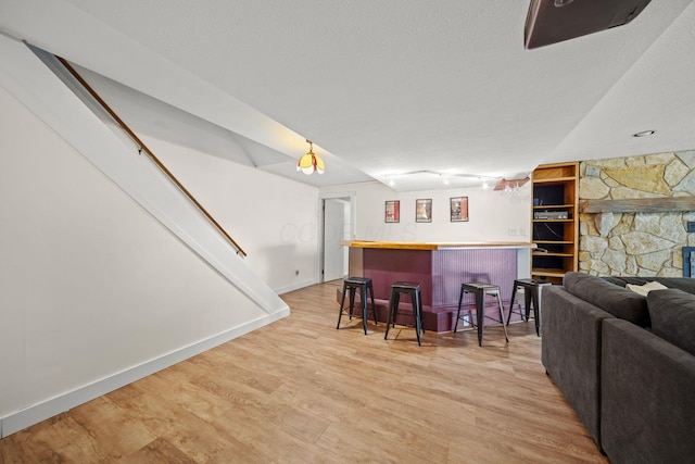 2825 Kings Corners Rd E, Mansfield, OH 44904 - indoor dry bar featuring light wood-style flooring, baseboards, and a textured ceiling