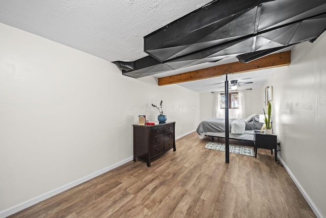 2825 Kings Corners Rd E, Mansfield, OH 44904 - bedroom featuring wood finished floors, baseboards, beam ceiling, and a textured ceiling