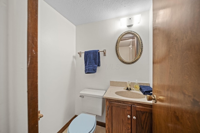 2825 Kings Corners Rd E, Mansfield, OH 44904 - half bath with a textured ceiling, toilet, and vanity