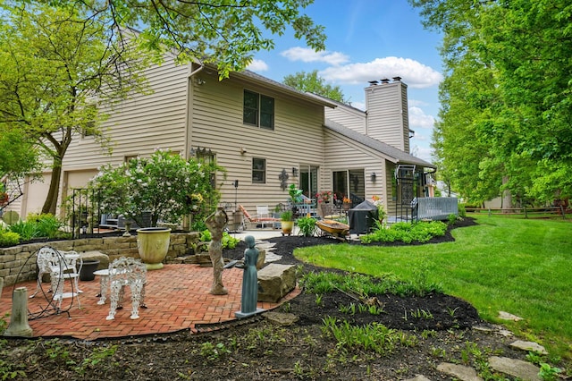 rear view of property with a patio and a chimney