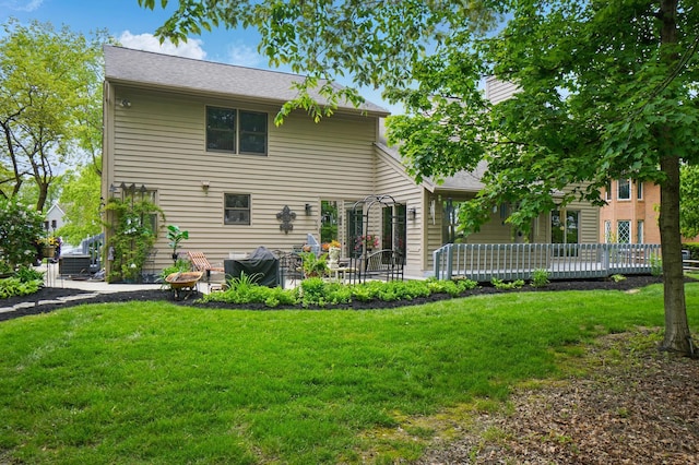 rear view of house with a yard, a patio area, and a deck