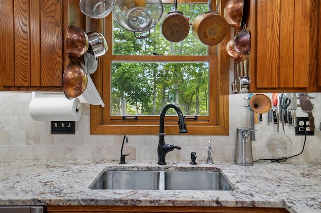 8292 Breckenridge Way, Columbus, OH 43235 - kitchen featuring brown cabinetry, decorative backsplash, and light stone countertops