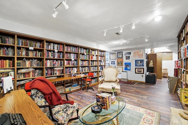 8292 Breckenridge Way, Columbus, OH 43235 - sitting room featuring rail lighting, bookshelves, and wood finished floors