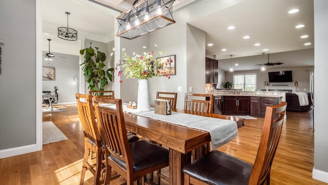 dining room with ceiling fan, light wood-style floors, recessed lighting, baseboards, and a chandelier
