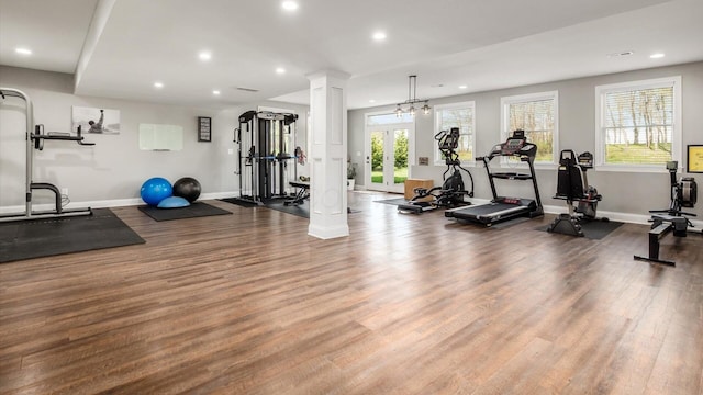 gym featuring ornate columns, recessed lighting, wood finished floors, and plenty of natural light