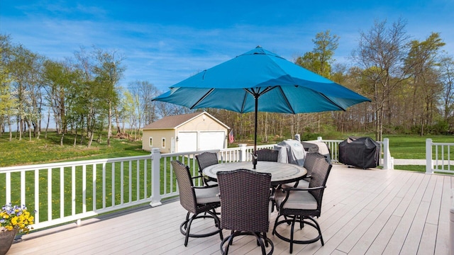 wooden deck with an outdoor structure, outdoor dining area, a yard, area for grilling, and a detached garage