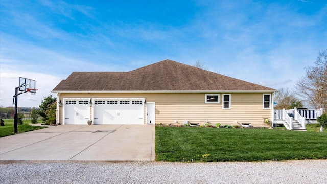view of side of home featuring driveway, a garage, a lawn, a wooden deck, and roof with shingles