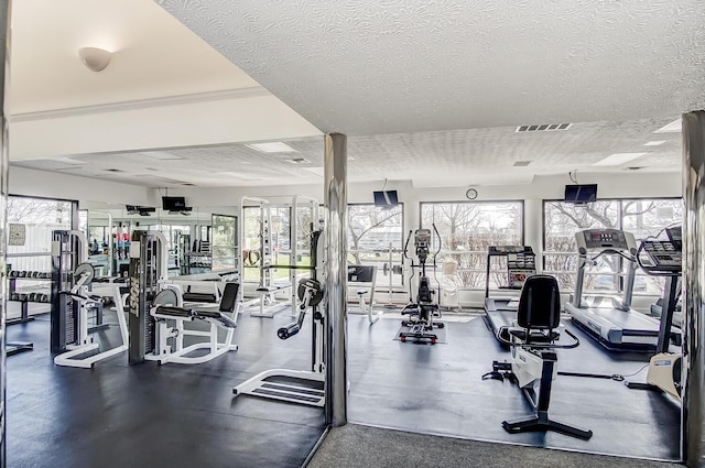 gym featuring visible vents and a textured ceiling
