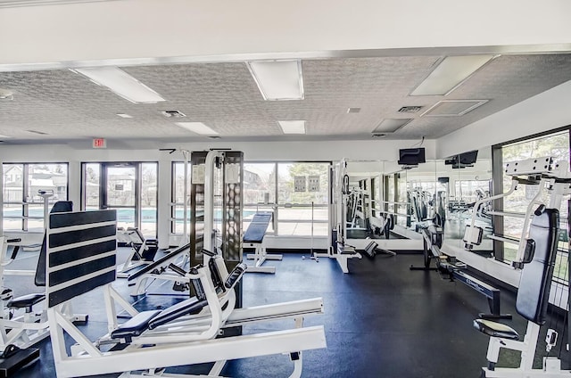 workout area with visible vents and a textured ceiling