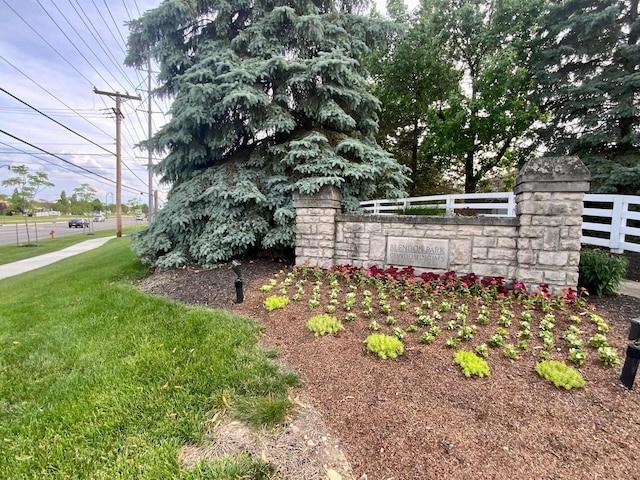 community sign featuring fence