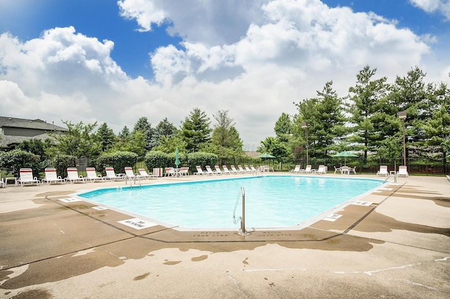 community pool featuring a patio and fence