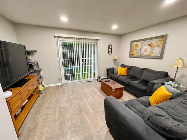 living area featuring recessed lighting, baseboards, and wood finished floors