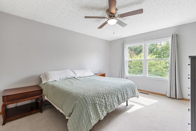 3102 Menzola Dr, Columbus, OH 43228 - bedroom with light colored carpet, baseboards, a ceiling fan, and a textured ceiling