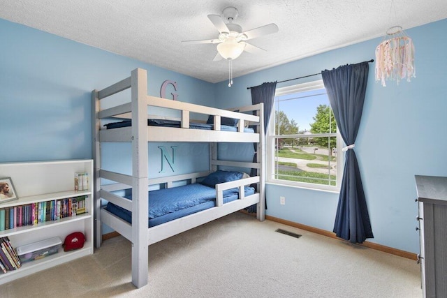 3102 Menzola Dr, Columbus, OH 43228 - carpeted bedroom featuring a textured ceiling, baseboards, and a ceiling fan