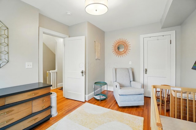 living area featuring light wood-type flooring and baseboards