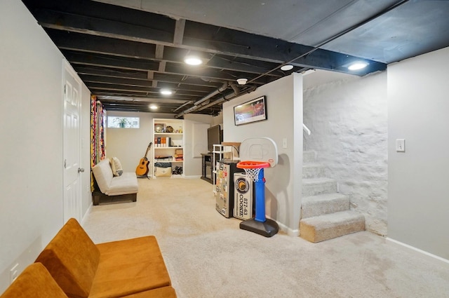 below grade area featuring carpet flooring, stairs, and baseboards