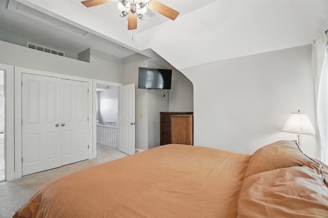 bedroom with carpet floors, ceiling fan, a closet, and lofted ceiling