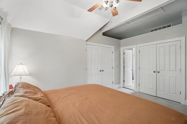 carpeted bedroom with multiple closets and a ceiling fan