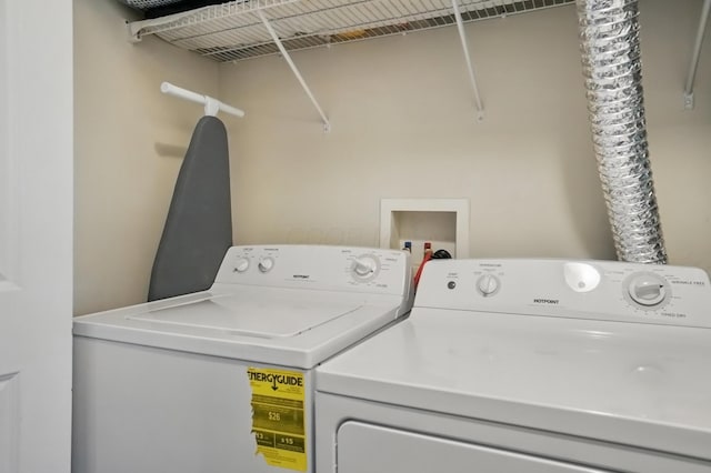 clothes washing area featuring washer and dryer