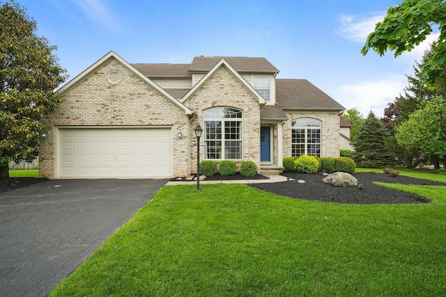 3998 Kul Cir S, Hilliard, OH 43026 - french country inspired facade featuring driveway, brick siding, a front yard, and an attached garage
