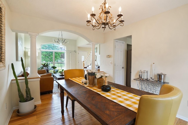 3998 Kul Cir S, Hilliard, OH 43026 - dining space featuring decorative columns, hardwood / wood-style floors, a notable chandelier, baseboards, and arched walkways