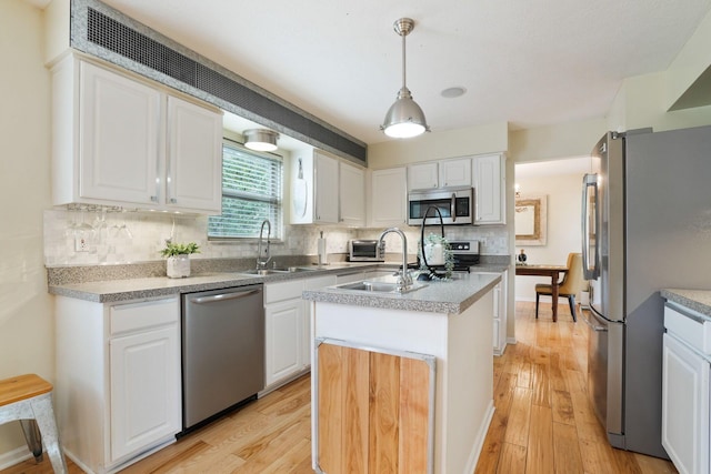 3998 Kul Cir S, Hilliard, OH 43026 - kitchen with a sink, light wood finished floors, an island with sink, and appliances with stainless steel finishes